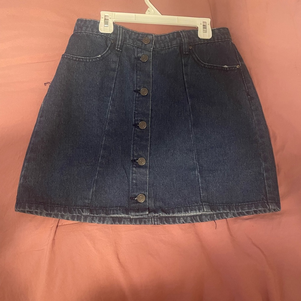 Denim button up skirt with two pockets on the back. Looks great with body suits!